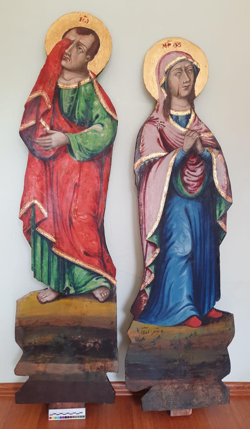 The Virgin Mary and Saint John, paired carved cut-out figures, after treatment