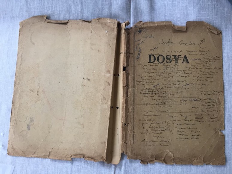 The DOSYA folder before treatment, with abraded boards and torn perforated spine