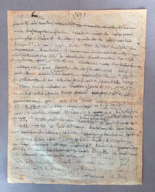 The manuscript leaf after treatment, tear joined with Japanese tissue and flattened under weighted acid-free paper
