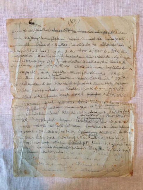 The manuscript leaf before treatment, broken in two along an old fold with staining